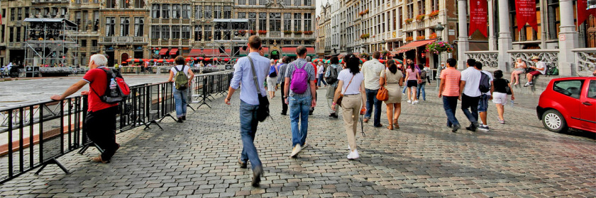 People walking away from camera in a European city setting